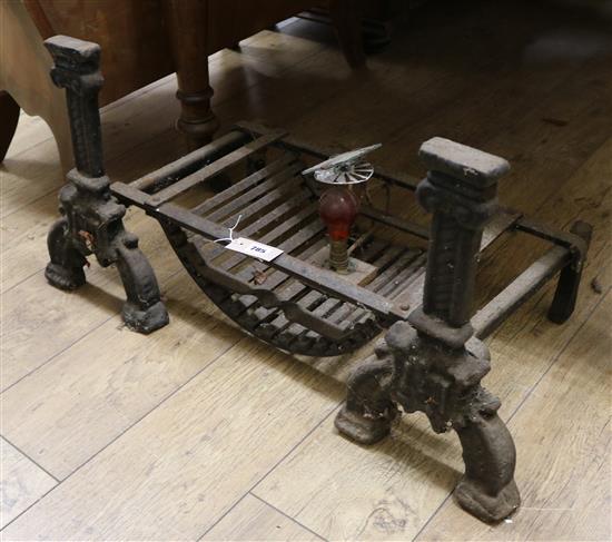 A pair of 17th century style black painted cast iron firedogs, combined with a fire grate W.65cm